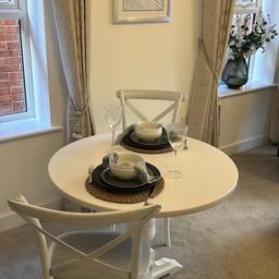 Ex-show home dining table and two chairs.