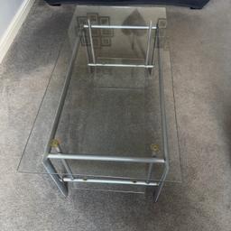 Glass two level coffee table
Silver legs
Glass top
glass bottom shelf (can be removed)

144 cm width
60 cm length
43 cm height