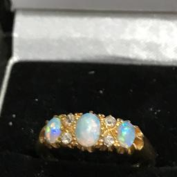 A stunning Opal n diamond set ring original opals not synthetic ideal gift or keeper ring size P very good condition hallmarked 18 ct no time wasters or silly offers will not be answered