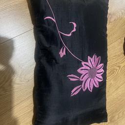 Fashion pillow for your bed 
Black in colour with a purple flower design