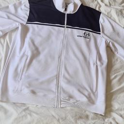 sergio tacchini tracksuit top says 4xL/ 5xL But Fits Like Mens XL/ 2xL. Retro style. 1st 2c will buysergio tacchini tracksuit top says 4xL/ 5xL But Fits Like Mens XL/ 2xL. Retro style. 1st 2c will buy. See photos for condition size flaws etc. I can offer try before you buy option but if viewing on an auction site viewing STRICTLY prior to end of auction.  If you bid and win it's yours. Cash on collection or post at extra cost which is £4.55 Royal Mail. I can offer free local delivery within 5 miles of my postcode. Listed on five other sites so it may end abruptly.
Ps. I've just watched the first episode of Netflix's new gangster series called 'The Gentlemen' and the main villain is wearing a very similar style to my two Fila tops and it's actually a Sergio Tacchini. I am selling a Sergio Tacchini top but it's a different fabric though. All 3 are super retro cool.