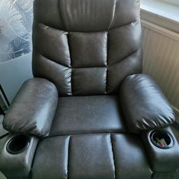Hardly used 2 manual recliner chairs brown imitation leather 2 front and side pockets and 2 cup holders in each chair was £238 each new