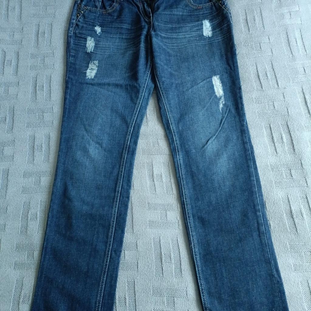 ladies boyfriend jeans. stud and ripped design.