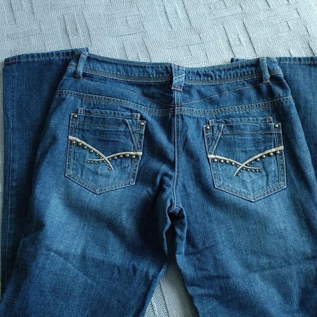 ladies boyfriend jeans. stud and ripped design.
