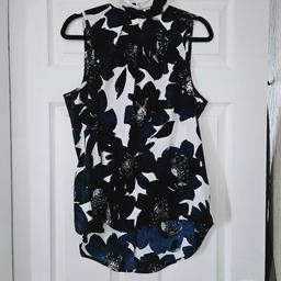 Navy blue and white colour floral top with a high neck and back zip fastening, size 16.

cash and collection only, thanks.
possible delivery to Conisbrough on Saturday mornings only around 11 am.