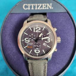 citizen eco drive watchbwith date, stainless Steel face with grey textile strap.