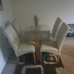 dinner table with 4 chairs and mat in pic. in very good condition no marks on chairs or legs absolute steal