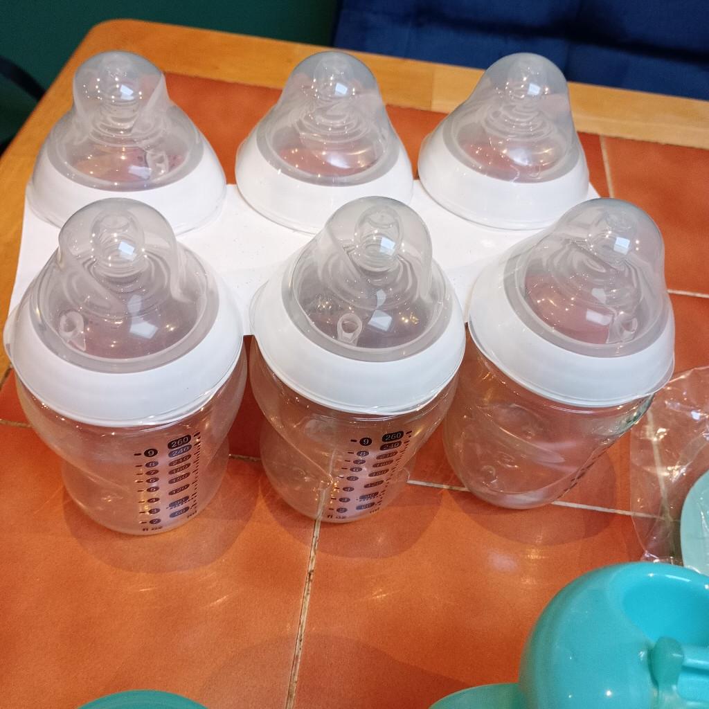 six feeding bottles slow flow 9 flozs tommee tippee brand new. toddler drinking cup, one bowl two spoons two baby food containers and a rubber bib,and a weaning book.