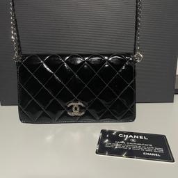 Chanel wallet with chain added to use as cross body bag.

Chain is unbranded.
The serial number inside is no not present properly dropped off due to use and age.
In fair condition with marks externally and fading internally and a tear as shown in photos.