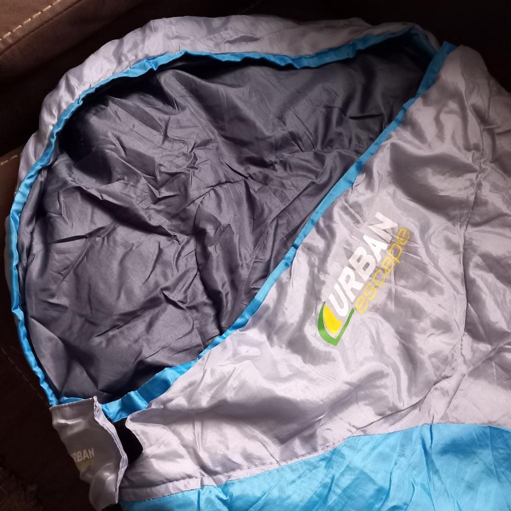 Urban escape Junior Tahoe mummy sleeping bag. Dual layer sleeping bag with drawstring bag. Bag has handle for easy transportation.

Great condition.

300 g/m². Suitable for late spring to early autumn.
Internal security pocket. Ridgehood. 2 may anti-snag zipper. Approx. 165cm in length and 70cm wide at the top end. Machine washable.

Have 4 available. £7.50 each.

OL7 area. Can combine postage