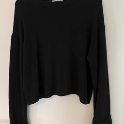 Black Zara jumper with turned up hem sleeves, size medium. Used item that is in good condition.