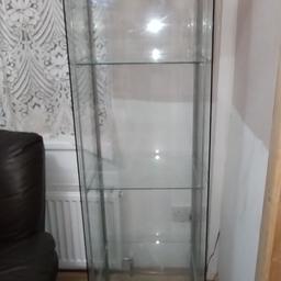 IKEA Detolf glass display cabinet 4 tiers high. Wooden top and bottom, with metal frame inside. There is a hole in the top for a bulb to light up the cabinet. Only selling it because we have limited space in our room. Smoke & pet free home