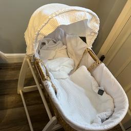 Natural Moses basket with white bedding and white rocking stand