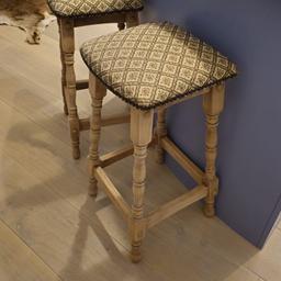 A pair of raw wood bar stools with tapestry padding
70cm high 
Seat is 35 x 35 cm