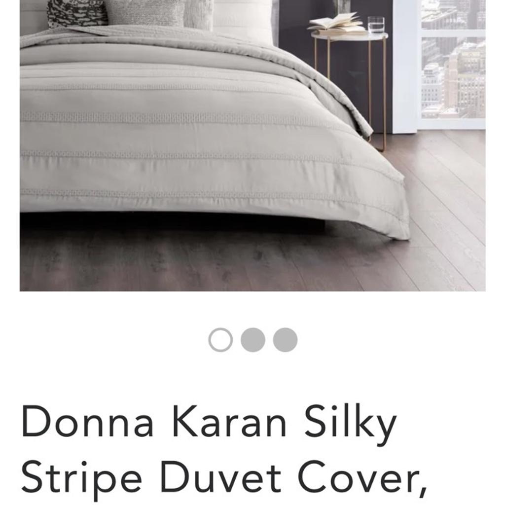 Donna Karan Silky Stripe Duvet Cover, Platinum Fall into a sweet slumber with the Donna Karan Silky Stripe duvet. Soft, sustainable, and hypoallergenic – the lyocell-silk blend spoils you with the comfort of your desires. The lightweight, breathable nature of silk and lyocell pampers sleepers even with sensitive skin types. Beyond the feel, lyocell is a sustainable alternative to traditional fabrics so you can rest soundly. The seed stitch applique gives this duvet sophisticated stripes for a classic look in your bedroom. With 6 grey pillowcases