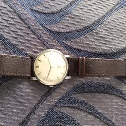 Omega watch man's 1962 with a brown lever strap. Lovely condition. Three hundred pounds