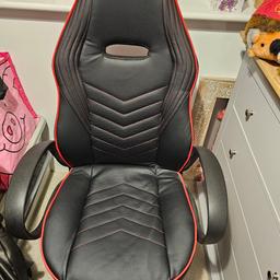 Gaming chair. Black with red trim. on casters. Height adjustable.  Good condition.