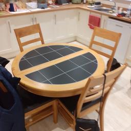 Extendable circular dining table for 4 - 8 persons with 4 chairs. Used, but still in good condition.
Table 1m 4cm diameter before extend. Extended measures 1m 53cm. Height 76 cm. Black tiled and beech surround. Centre column leg.
4 beech chairs seat height 47cm. Faux leather seats. Please, see photos.
Collection only, please. Cash on collection.