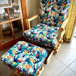 A newly refurbished gliding / rocking nursing chair and footstool in excellent used condition. The chair reclines, and both chair and stool glide smoothly for a very comfortable space to sit with your little one.
Both have been fully re-covered with a fun jungle animals upholstery fabric with coordinating covered buttons for a fresh, new feel. All cushions are well padded and the seat and footstool covers can be removed for washing.