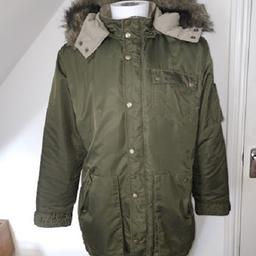 Size XL (24" P2P, 33" Length)

Green hooded parka from Italian brand Energie, very warm quilted jacket with detachable faux fur trim hood.
Zip & Stud fastening, adjustable waist with a tie cord, multiple pockets & a branded badge on the arm.

NOTE: There is a fault on a rear seam(see pics) the seem is starting to split, this may be easy to repair!!
I am only selling as I have out grown it & it hasnt been worn for a few years as I have failed to lose my winter bulk!!!!!