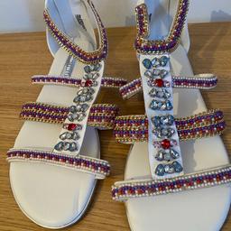 New gladiator style, flat sandals with multicolour, crystal and bead, embellishment. Zip on back of sandals. Size 6.  Brand Atmosphere