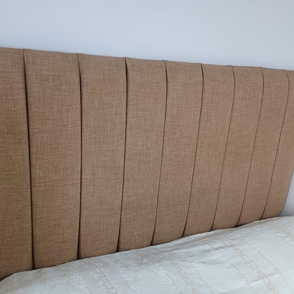 A smart tall headboard that sits on the floor and fitted to the base of a divan . Only had a couple of months in spare room. Selling due to a move. paid £240. Can deliver locally.