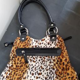 Soft animal print handbag with faux leather handle and trims.34cm at bottom and approx. 20cm high. Main compartment has zip fastening, with an inner zip compartment and phone compartment. Has an outside zip pocket too. Never used and in excellent condition. As well as free collection from us, we also offer UK postal delivery for £3.19.