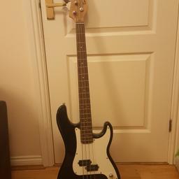 THIS IS FOR A TENSON BLACK ELECTRIC BASS GUITAR WITH WHITE FACE PLATE 
4 METAL STRINGS.
THERE IS A SCREW MISSING ON THE BOTTOM OF THE WHITE FACE PLATE. IT COULD DO WITH A SCREW IN THE PLATE AS IT LIFTS UP WHEN AN AMP LEAD IS TAKEN OUT.
LARGE SCRATCH DOWN THE BACK. SOME SCUFFS AND KNOCKS AROUND THE EDGES.
GOOD WORKING ORDER. GOOD CONDITION.