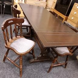 This traditional country cottage style extending solid oak dining set is in good used vintage condition. The chairs are nice and solid. The table looks like it has been stained with a satin varnish. Hard to tell for sure if the table top is veneered or not? There will be marks on the wood on both table and chairs due to use and some paint marks... There are four chairs included in the set, but you could get more chairs to fit around the table... Definitely six and maybe eight at a push.
The extending sections will slide independently from each end and sit underneath the main central piece to make smaller. One leaf can be left extended whilst the other can be tucked inside. £75 FULL SET.

Non-extended - 42.5 inches long x 28 inches wide x 30.5 inches high.
One leaf extended - 57 inches long.
Fully extended - 69 inches long.

Our second hand furniture mill shop is LOW COST MOVES, at St Paul's trading estate, Copley Mill, off Huddersfield Road, Stalybridge SK153DN... Helen on 07734 330574