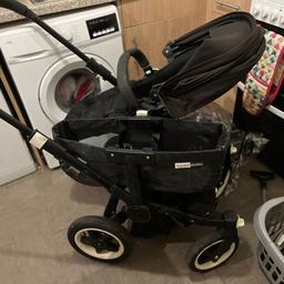 Bugaboo donkey 2 duo black with 2 seats ,carry cot, rain covers ,basket and personal belonging bag for handle.