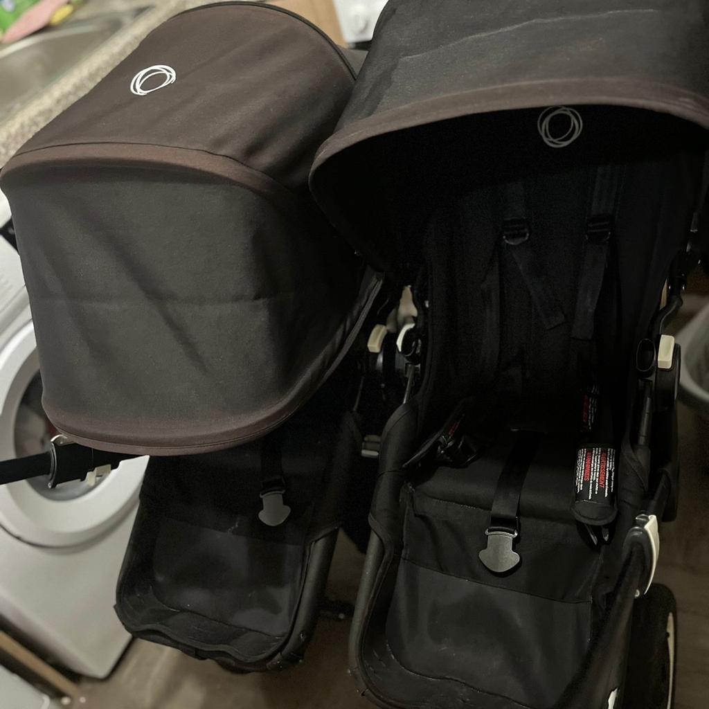 Bugaboo donkey 2 duo black with 2 seats ,carry cot, rain covers ,basket and personal belonging bag for handle.
