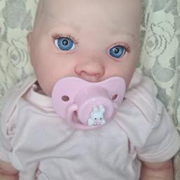 Hi im Stacy,  I'm a reborn artist.  This beautiful reborn doll Flossy has been painted with heat set paints, has beautiful details of veins and mottling. 

lovely blonde painted hair and blue eyes.
she is under £4 not sutiable for you g children under 13