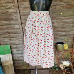 Ruffles & Lace (independent label) handmade retro midi skirt. Cream fabric with red and green cherry print. Contrast red stitching. High waisted. Red zip up side with large button and loop a little further round. Pleated waist. 
Approx size 8 10
Waist measures 30"
Length 28.5"