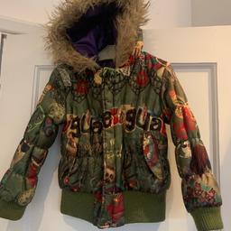 Desigual Girls Coat Age 4 Years, 

This is a Reversable Quilted Coat one side purple and one side patterned green (eye catching). 

Good condition apart from last press stud has come out (see photo). With two pockets, furry hood and zip fastens with additional press stud fastening if you want. 

Postage or collection Woodford, IG8

Smoke/pet free home.