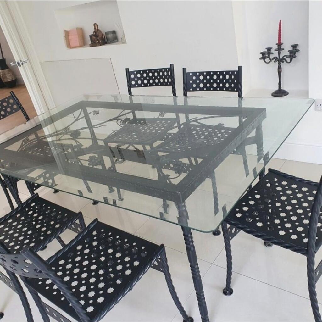 hand made wrought iron glass dining table with vines, leaves work in iron. 6 matching chairs 67inch x 41 inches. very good condition. buyer to collect cas only