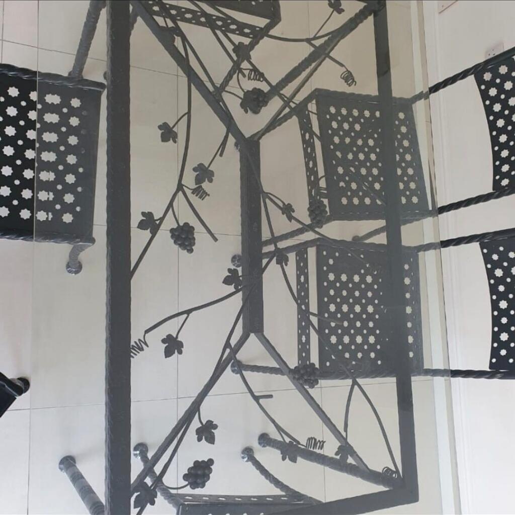 hand made wrought iron glass dining table with vines, leaves work in iron. 6 matching chairs 67inch x 41 inches. very good condition. buyer to collect cas only