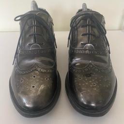 Dune London Women’s Shoes Farnley Lace Up Brogues Pewter Patent Leather Freeflex Soles
Shoe size UK 7 / US 9.5 / EU 41
Used in good condition 
Please expect marks commensurate with being used, check photos for further details of condition. 
(Shoes trees not included)
Invest in retro comfort with these Farnley Lace Up Brogues by Dune. Stylish and easy-to-wear, the design comes with traditional lacing, round toe and a low block heel. Wear with various types of trousers - from jeans to cigarette trousers.

Check out my other listings for more quality branded, vintage, retro and new clothing items. 

Same working day despatch 
Or cash on collection in person welcome from DA7.