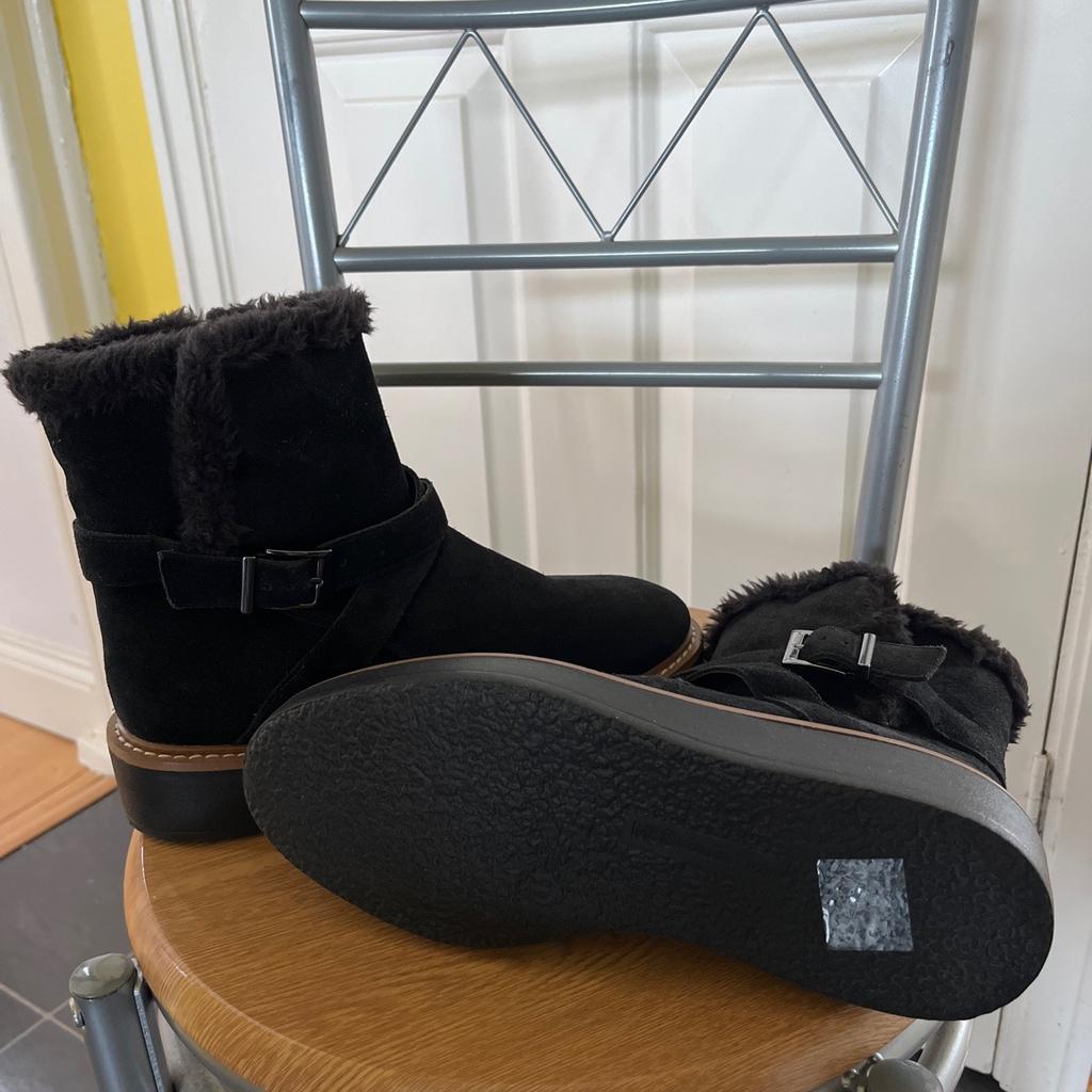 Brand new, black suede leather ankle boots with fur lining, size zip, buckle, and small platform sole, size 4.5 by M&S. Were £50 new.