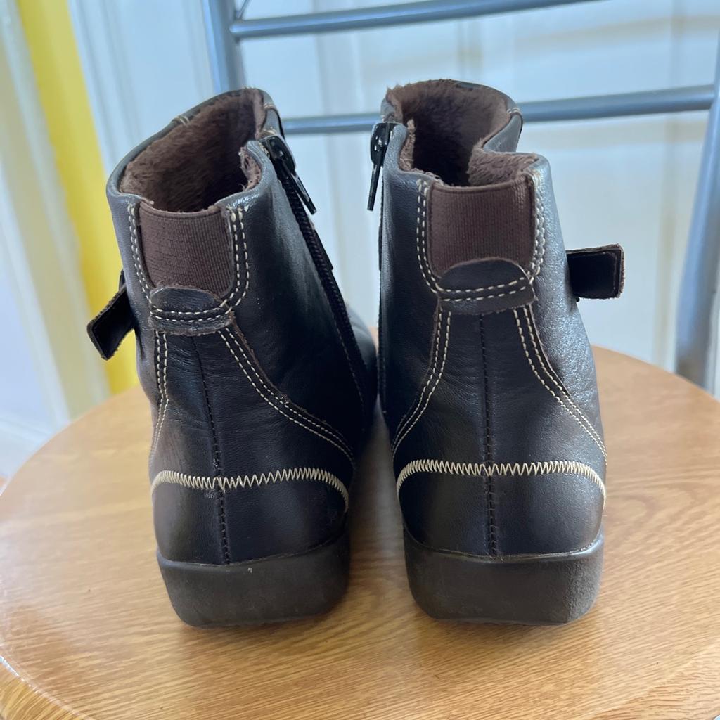 Brown leather ankle boots with fleece lining, buckle and side zip, size 4.5 wide fit, by K at Clark’s.
Worn but still plenty of wear left in them.