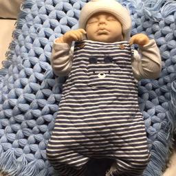 Reborn boy doll I have made him he is 21 inches in height and has real eyelashes and wearing brand new clothes size newborn . Any more questions just ask .