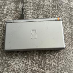 Grey Nintendo DS lite. Has a black line on top screen at the bottom but doesn’t affect the screen much or play. Original charger