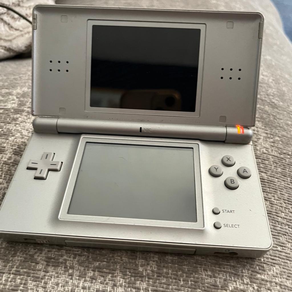 Grey Nintendo DS lite. Has a black line on top screen at the bottom but doesn’t affect the screen much or play. Original charger