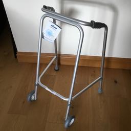 Brand new height adjustable walking frame 
with wheels.