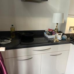 Used but in great condition. Modern cream gloss kitchen units with chrome handles- sink, AEG induction hob, extractor, integrated Beko fridge freezer, dishwasher, AEG washer/dryer, microwave oven and oven /grill., Wine cooler, Bottle rack, Black worktop included