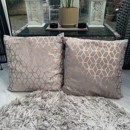 2 grey and rose gold cushions which are like new. Cost over £14 each.