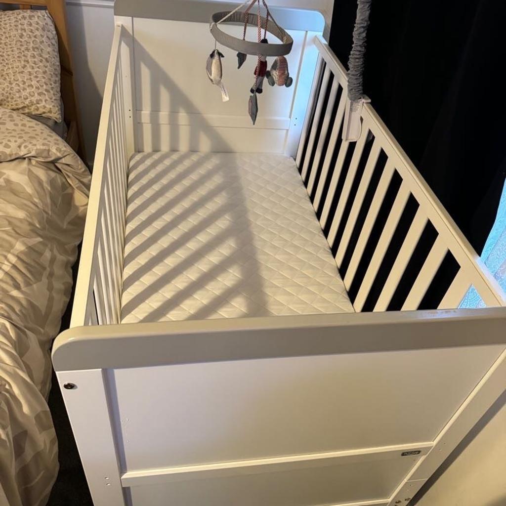 White cot basically brand new my son only slept in the cot couple times mattress is fresh. The cot only has couple scratches due to moving around in my house. It also comes with the changing baby part