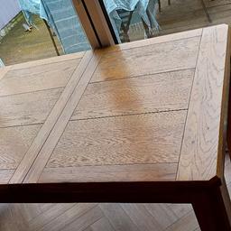 this is a high-quality table and chairs that cost nearly £2000.00 new. it has to added pieces to extend it that fix together using metal clips. the table moves out and in on metal chains that are also clipped into place when you have finished ajusting. it has had a lot of use. However, it could be restored to be as good as new. All it needs is the table top to be sanded a little and re varnished. the chairs have a little damage on the leather look piped edges as this has come away over the years, I have taken a close up picture of this to help illustrate this, but there are no rips in the material, and the chairs are still in good working order. if you prefer you could buy covers for them. any questions please message me thanks for look