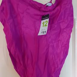 New with tags silky material bodysuit Size 12 pink purple colour pick up only Heckmondwike please see my other post thanks.