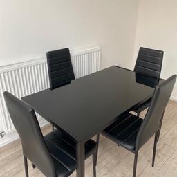 From Laura James a glass dining table set -4 seater in Black.
Table in good condition a few scratches, the chairs have wear tear. The chair are faux leather.

Table Size: W:120cm (47") D:70cm (28") H:75cm (30")
Chair: W:42cm (17") D:52cm (20") H:98cm (39")

Collection ONLY. Message me for more info and images. Open to negotiate