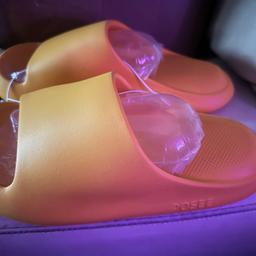 Brand new orange size 5 unisex crock style slip on shoes.

RRP £12 per pair